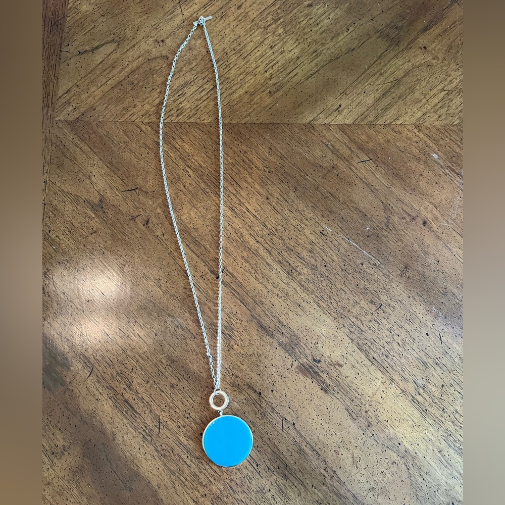 Turquoise pendant on gold chain.